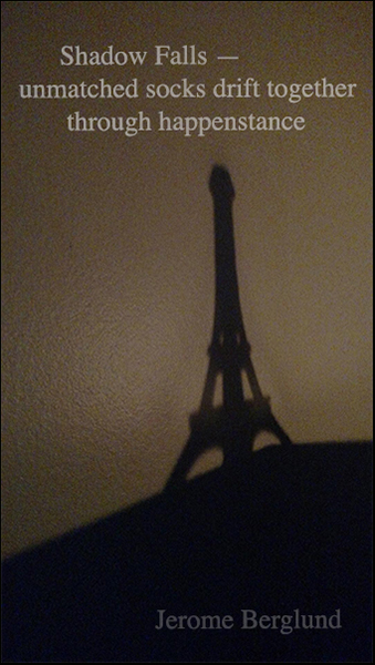 'shadow falls— / unmatched socks drift together / through happenstance' by Jerome Berglund